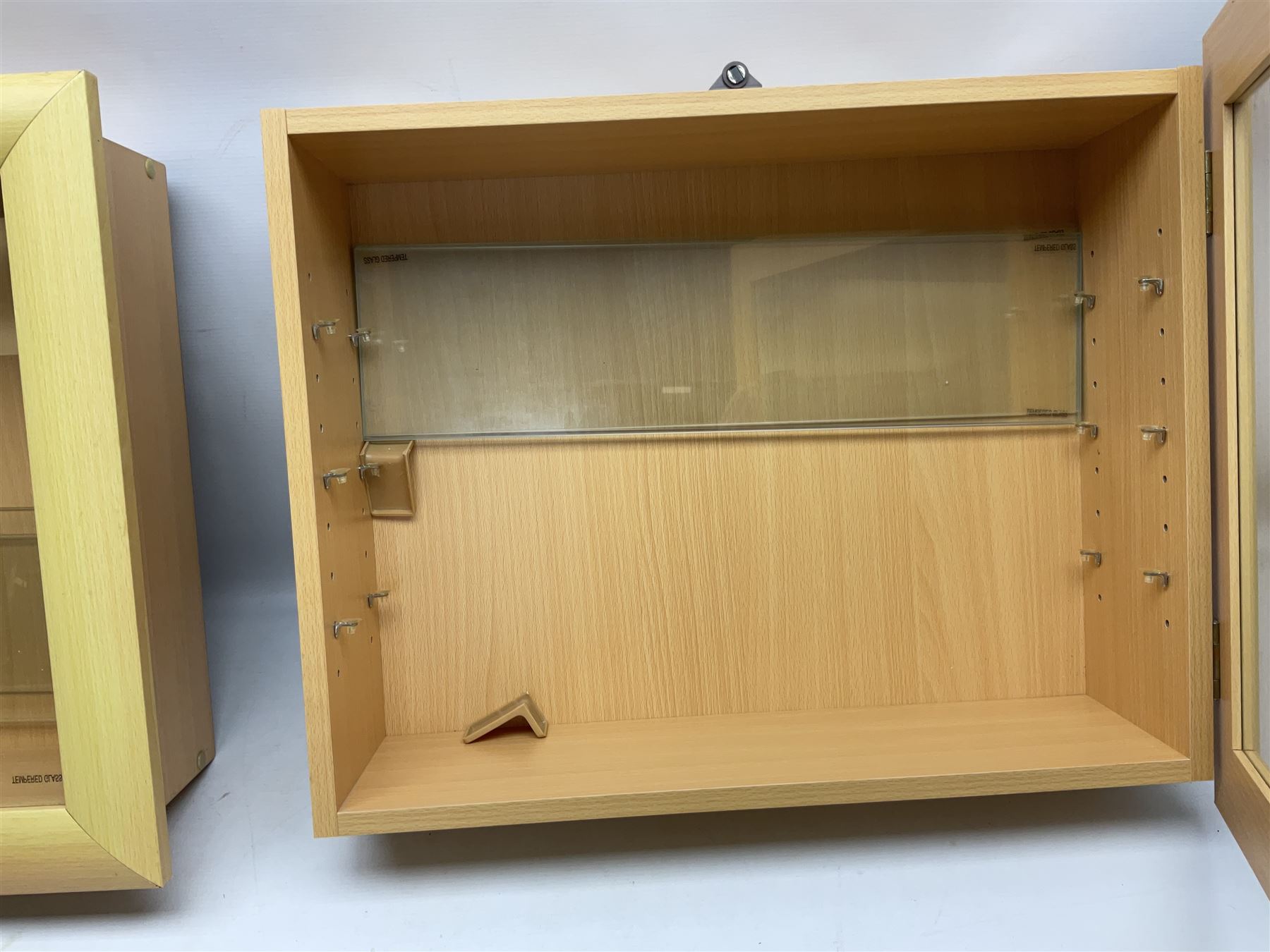 Set of four Livarno wall mounting model display cabinets, each with simulated beech finish and side hinged glazed door enclosing adjustable plate glass shelves W62.5cm H50cm D17cm (4)