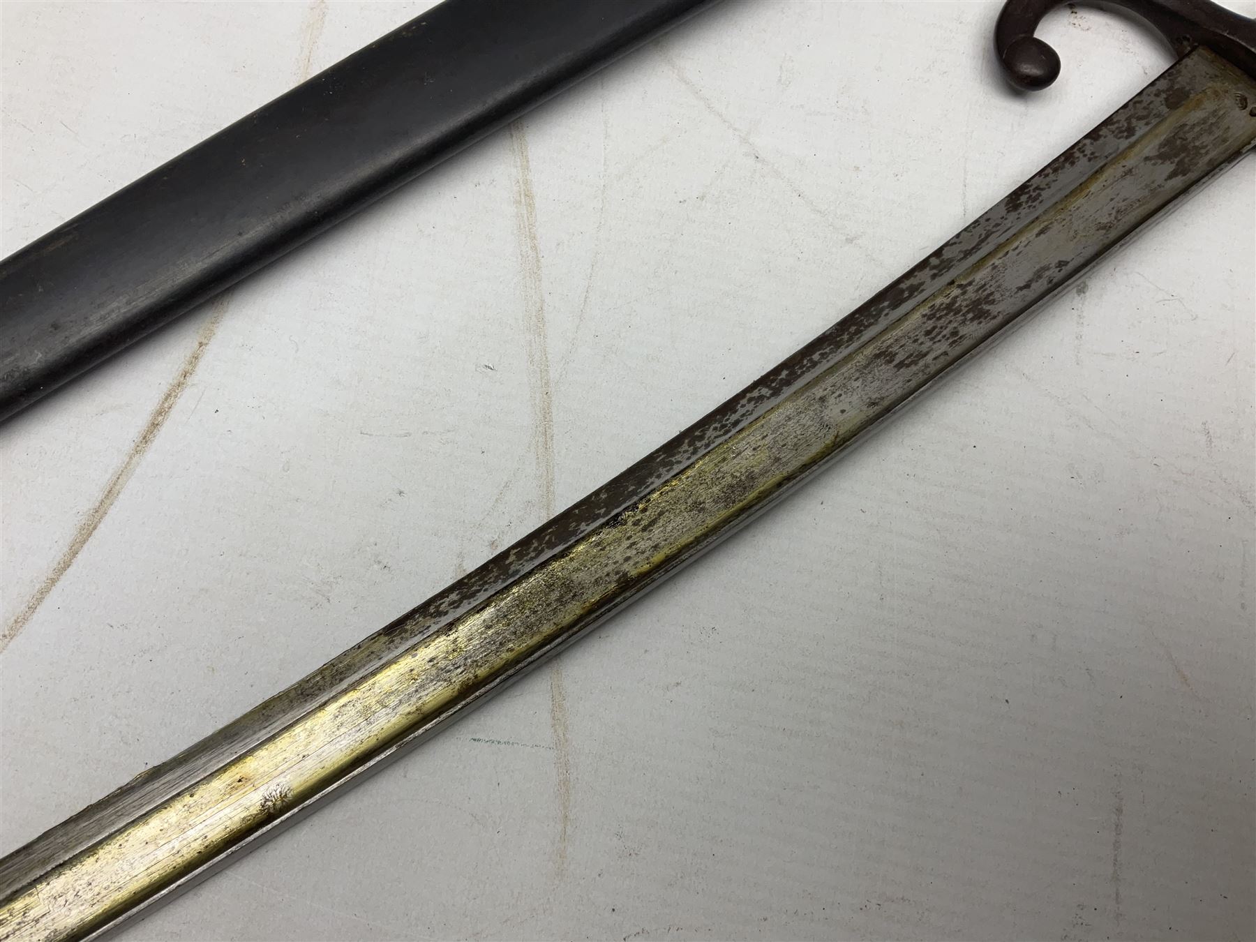 French Model 1866 Chassepot bayonet with 57cm curving fullered steel blade dated 1873 No.L63963; in steel scabbard with conforming number L71.5cm overall; and French St. Etienne Gras bayonet dated 1878 No.K10674 in steel scabbard numbered 79437 (2)