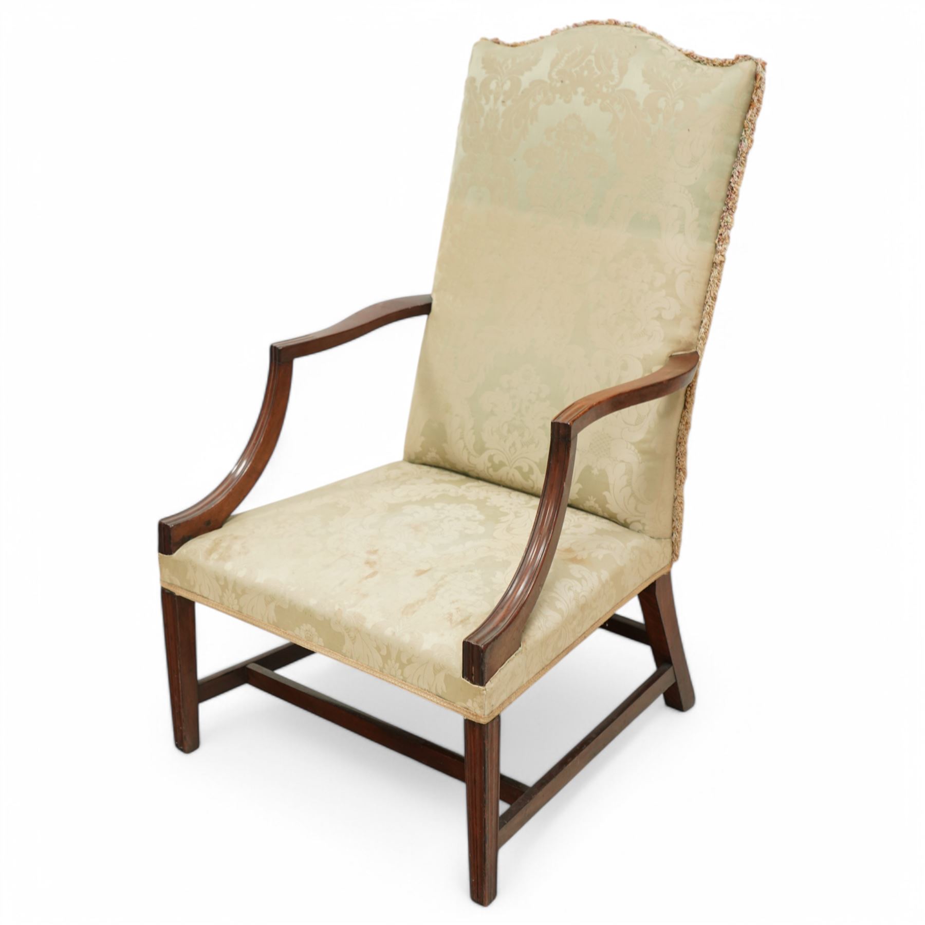 Georgian design mahogany framed Gainsborough armchair, arched cresting rail over shaped arms on curved and moulded supports, upholstered in pale green fabric with repeating foliate pattern, on square tapering moulded supports united by plain stretchers 
