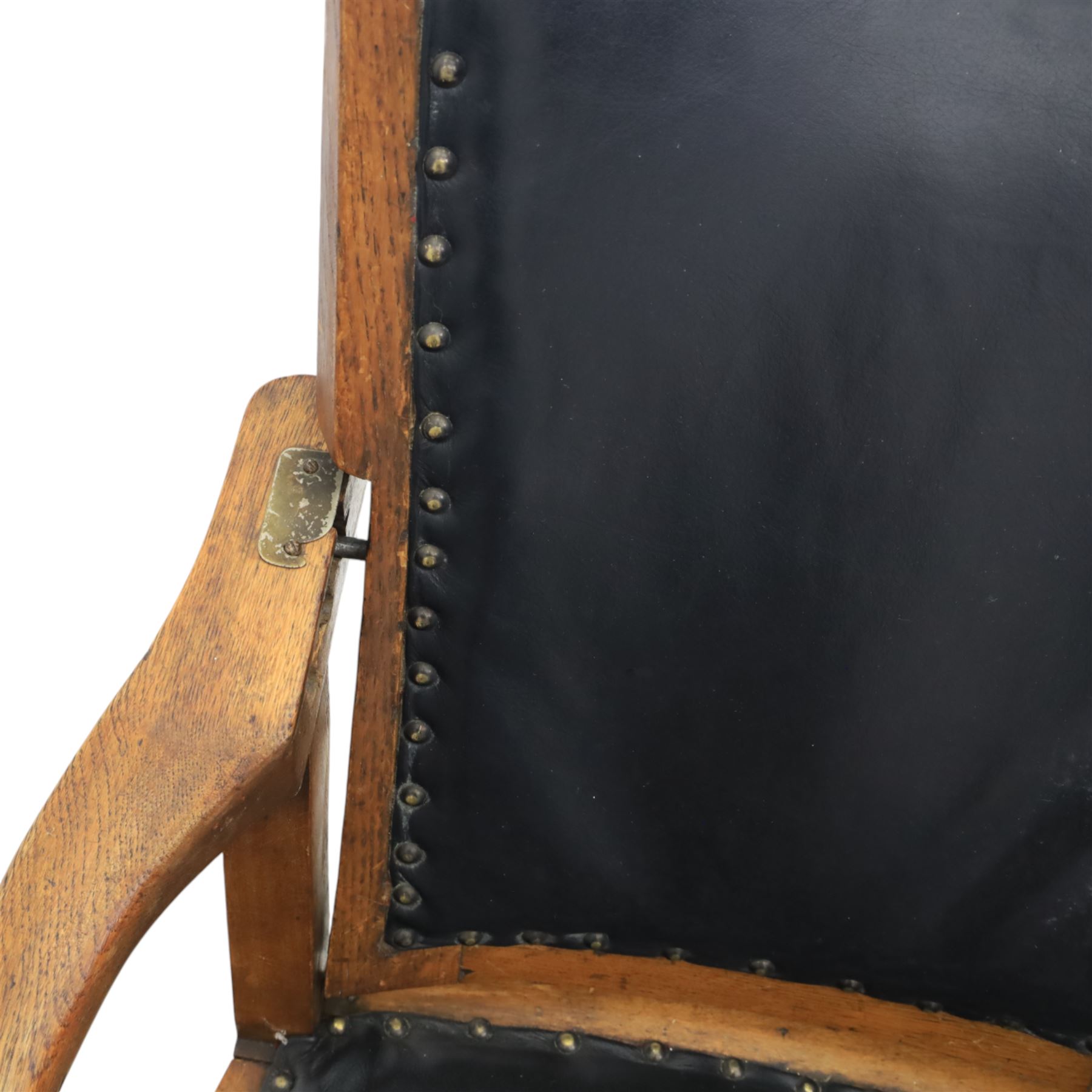 20th century oak recliner armchair, the curved back upholstered in leather with brass stud edging, hinged reclining back operated by side ratchet fittings, leather upholstered seat, shaped open arms, raised on cabriole legs