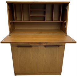 Mid-20th century teak bureau, fall front enclosing fitted interior, one long drawer over double cupboard 