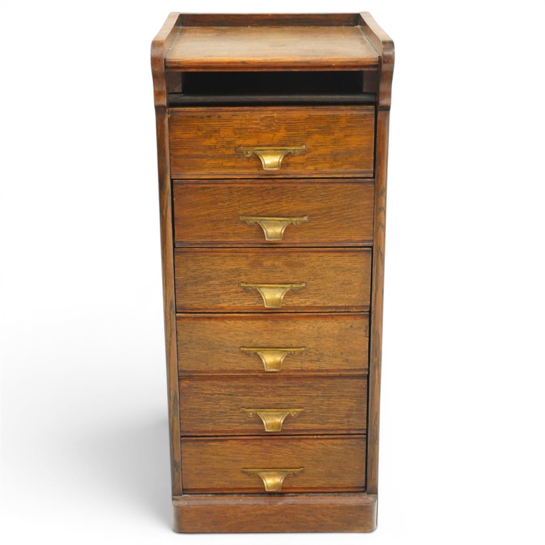 Edwardian oak pedestal filing cabinet, rectangular top with raised three-quarter gallery top, fitted with six drawers with interior paper-stays and brass handles, on plinth base