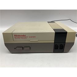 Nintendo Entertainment System (1985) console with two controllers, accessories and instruction booklet. NES Games ‘Duck Hunt’ with Nintendo Zapper gun, ‘Pinball’ and ‘Super Mario Bros.’, all with original sleeves and instruction booklets. NES game ‘Super Mario Bros. 2’ cartridge only