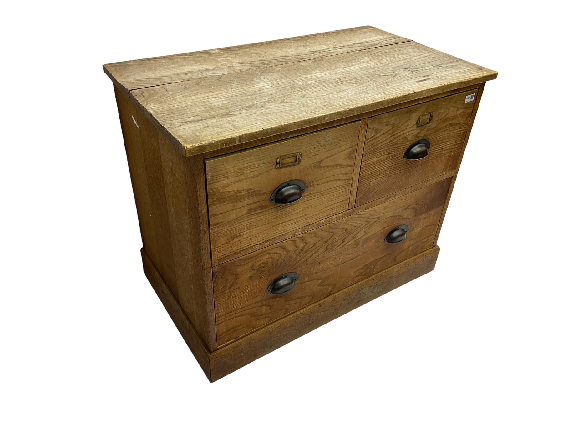 Early to mid-20th century oak chest, fitted with two short drawers over one long drawer, raised on plinth base