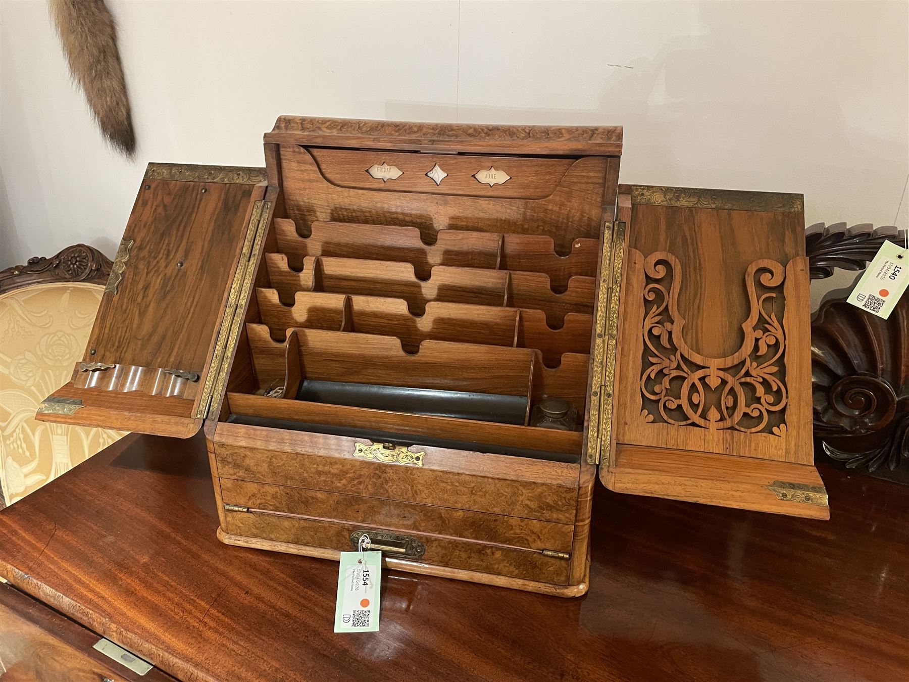 19th century burr walnut correspondence box, the sloped front opening to reveal a fitted interior with perpetual calendar, letter racks, and pen tray between two inkwell recesses, above a pull out draw with recessed brass handle, H41cm L40.5cm D28.5cm