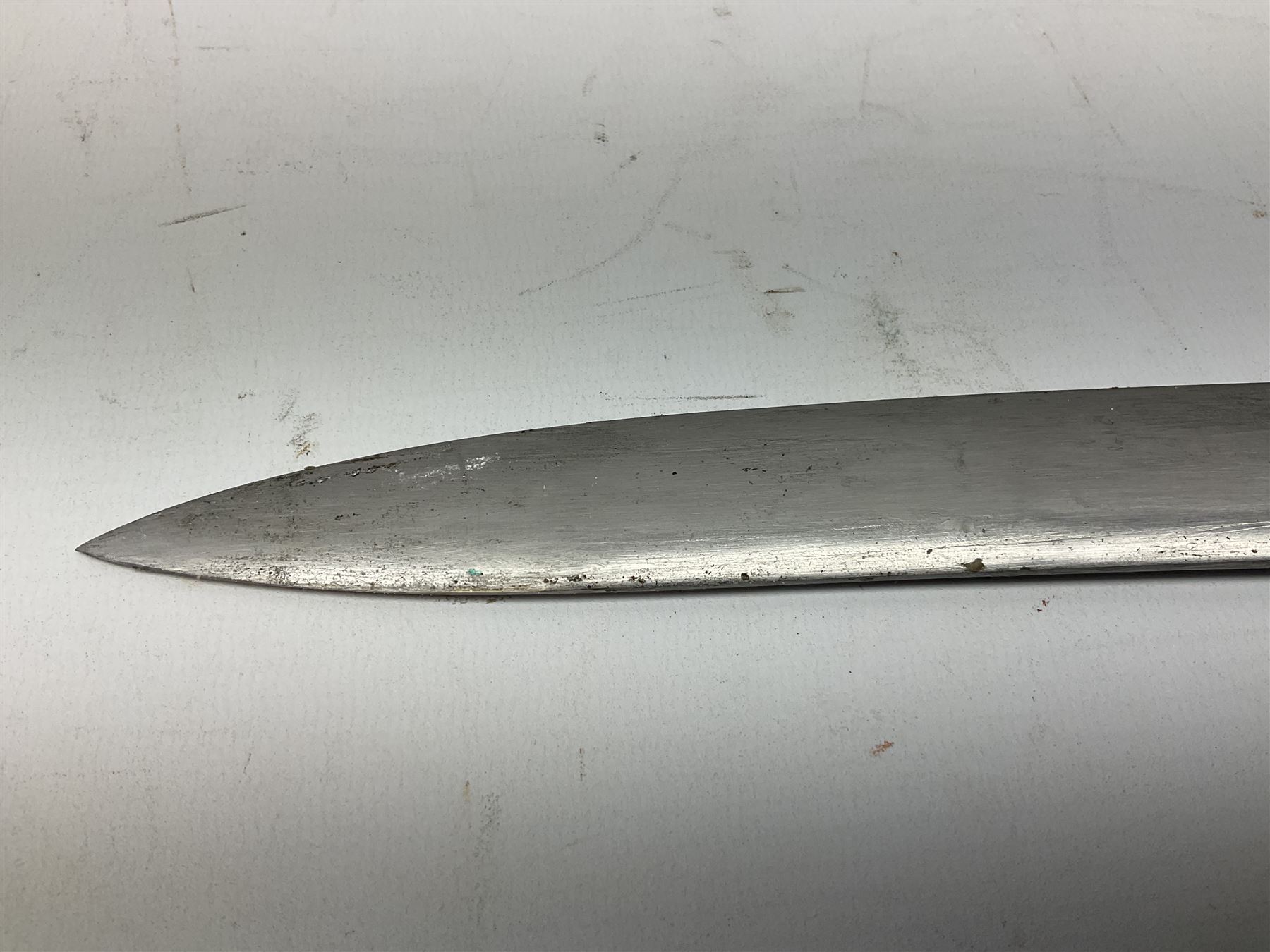 Turkish Model 1874 sword bayonet with 57.5cm curving steel fullered blade and chequered black grip, in steel mounted leather scabbard L75.5cm overall