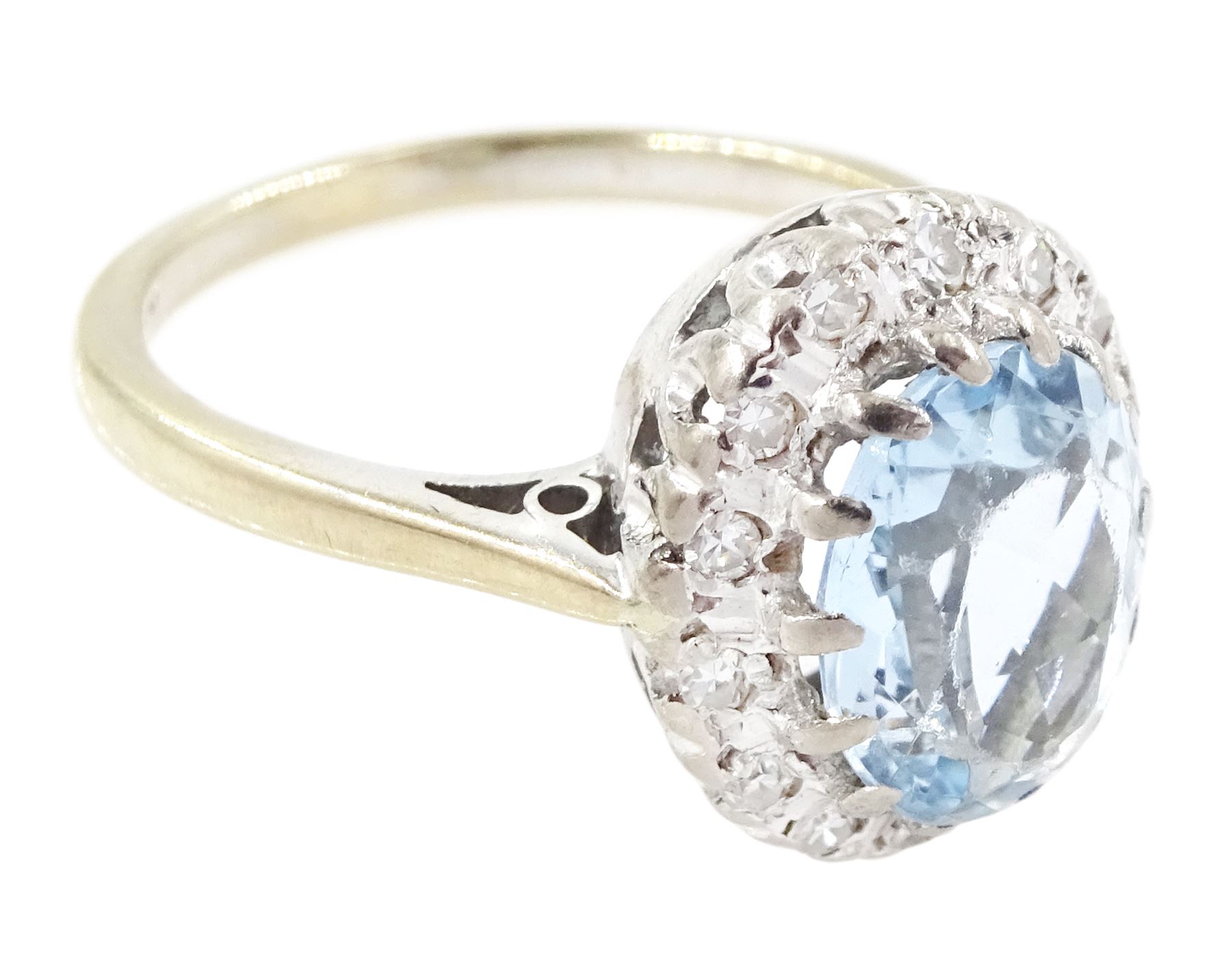 White gold aquamarine and diamond cluster ring, oval cut aquamarine of approx 1.35 carat, with single cut diamond surround, stamped 18ct