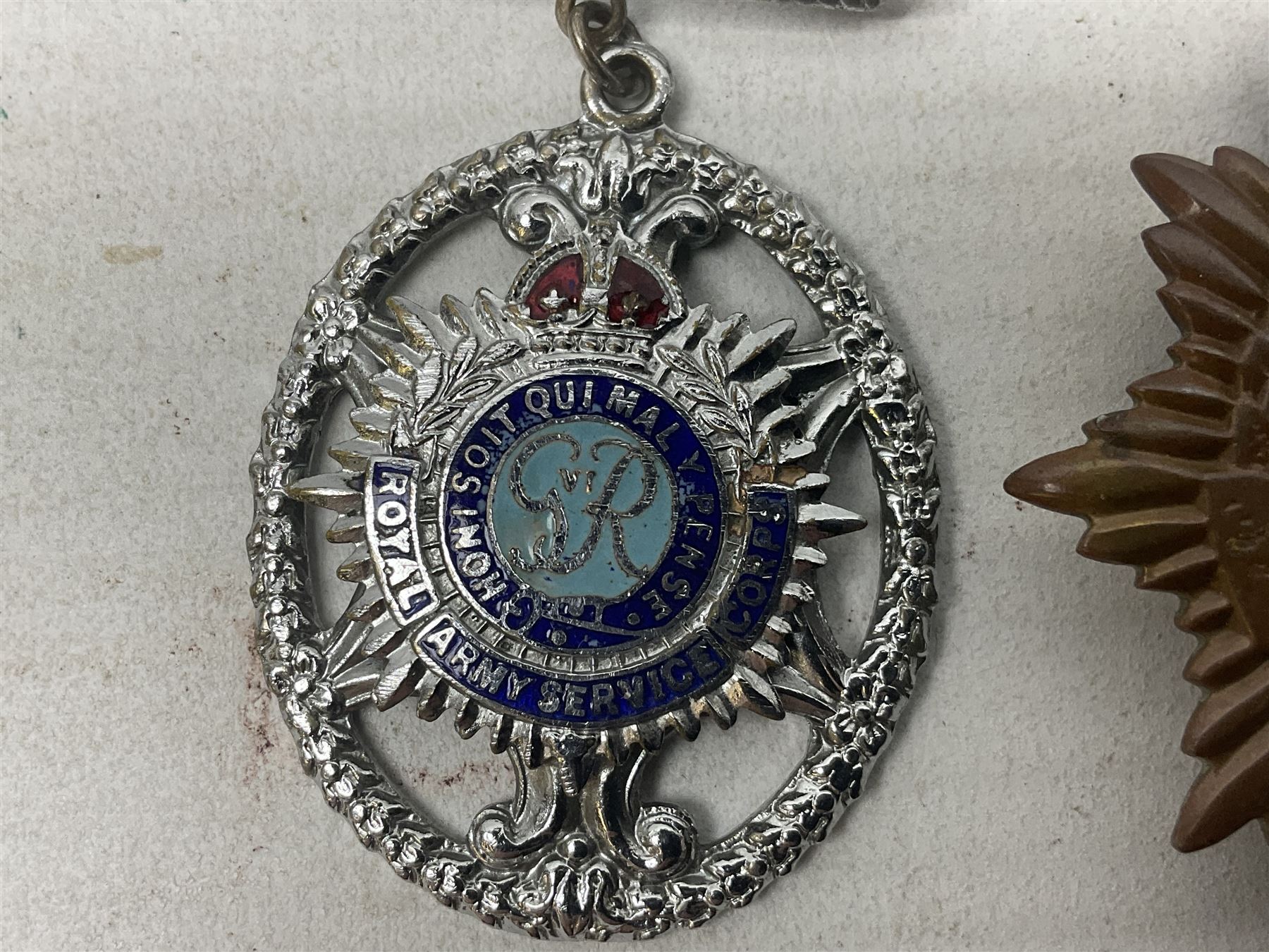 WW2 group of four medals comprising 1939-1945 War Medal, Defence Medal, Italy Star and 1939-1945 Star; with Royal Army Service Corps cap badge and RASC chrome and enamel sweetheart brooch