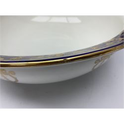 Early 20th century Bishop and Stonier four piece toilet set, comprising washbowl, wash jug, toothbrush pot, and chamber pot, each  decorated with deep blue band and husk swags and festoons in gilt, with printed Caduceus Bisto marks beneath and printed retailers mark 'Manufactured for Harrods Limited London', wash bowl D43cm, wash jug H31.5cm