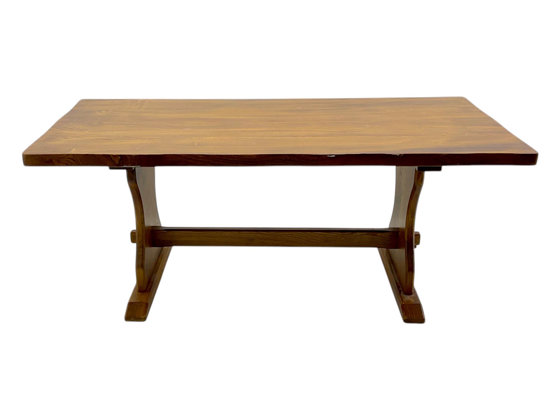 Late 20th century oak trestle table, rectangular top with naturalistic edge, supported by two curved pedestal bases united by central stretcher, on block feet