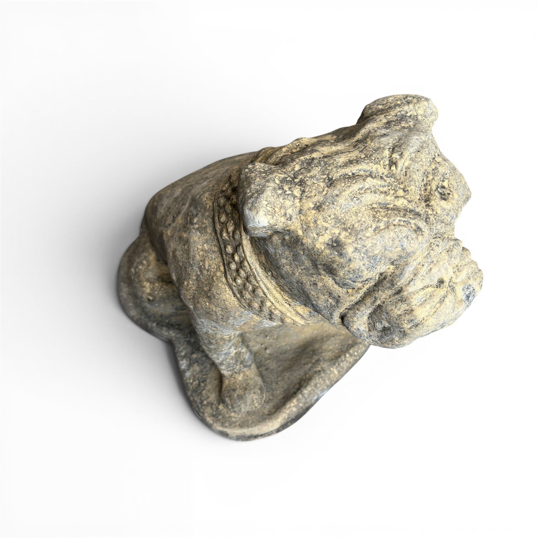 Cast stone garden statue on the form of a seated British bulldog with studded collar on a shaped rectangular base