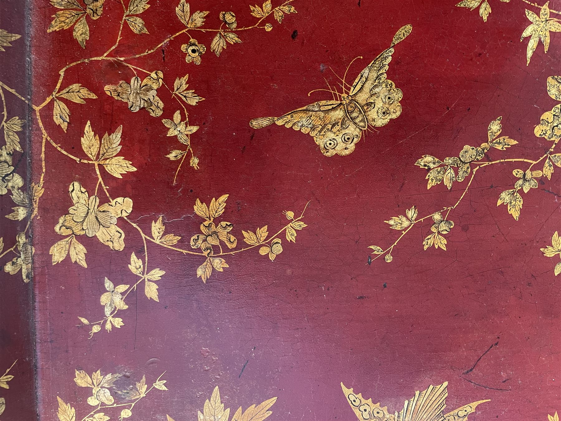 Early 19th century red lacquered papier-mâché tray by Clay of King Street Covent Garden, of rounded rectangular form, painted in gilt with large foliate sprays and butterflies, impressed verso CLAY KING ST COVENT GARDEN, W66.5cm D48.5cm