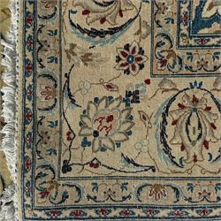 Nain Persian rug, hand knotted with a central medallion surrounded by a symmetrical arrangement of floral motifs, arabesques, curvilinear vines on an ivory background with teal and burgundy colours 