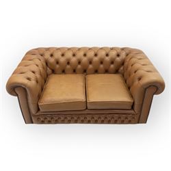 Contemporary tan leather chesterfield settee, deep button upholstered throughout with rolled arms and back of equal height, brass stud detailing, twin seat cushions