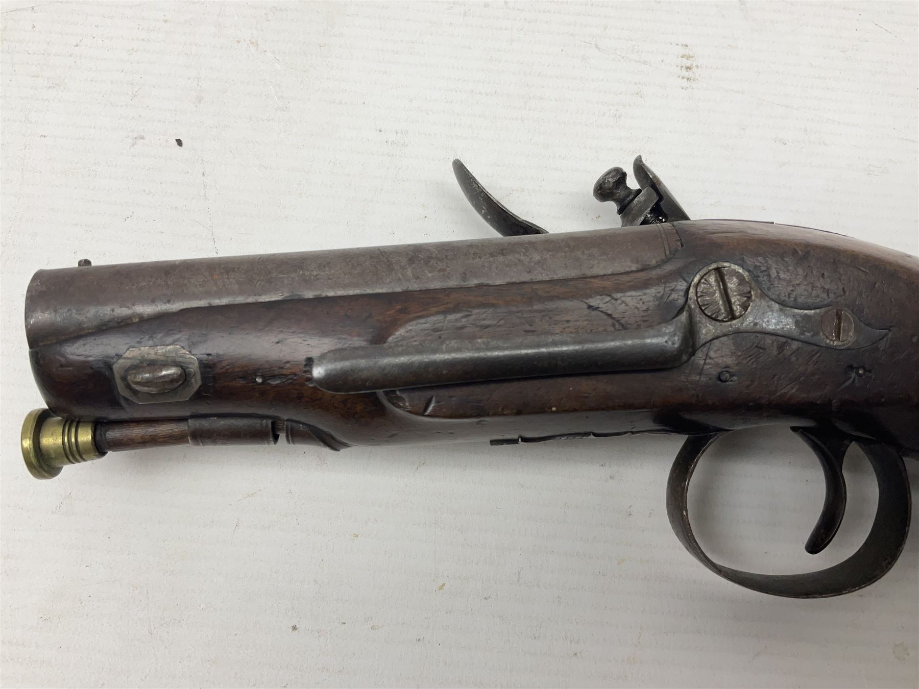 Early 19th century Wm. Hollis flintlock belt or pocket pistol, approximately 20 bore, the 10cm barrel with ram rod under, engraved lock plate with maker's name and roller frizzen, engraved trigger guard with pineapple finial and walnut stock with chequered grip L25cm overall