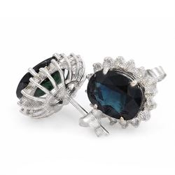 Pair of 18ct white gold sapphire and diamond cluster earrings, each stud set with a single oval cut sapphire, surrounded by sixteen round brilliant cut diamonds, total sapphire weight approx 6.65 carat, total diamond weight approx 1.00 carat