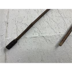 Native long-shafted spear, the large iron head with central medial ridge and decorative neck, on plain circular haft L260cm; and another similar Native long-shafted spear with cane haft L249cm (2)