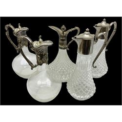 Collection of five silver-plate mounted glass claret wine jugs