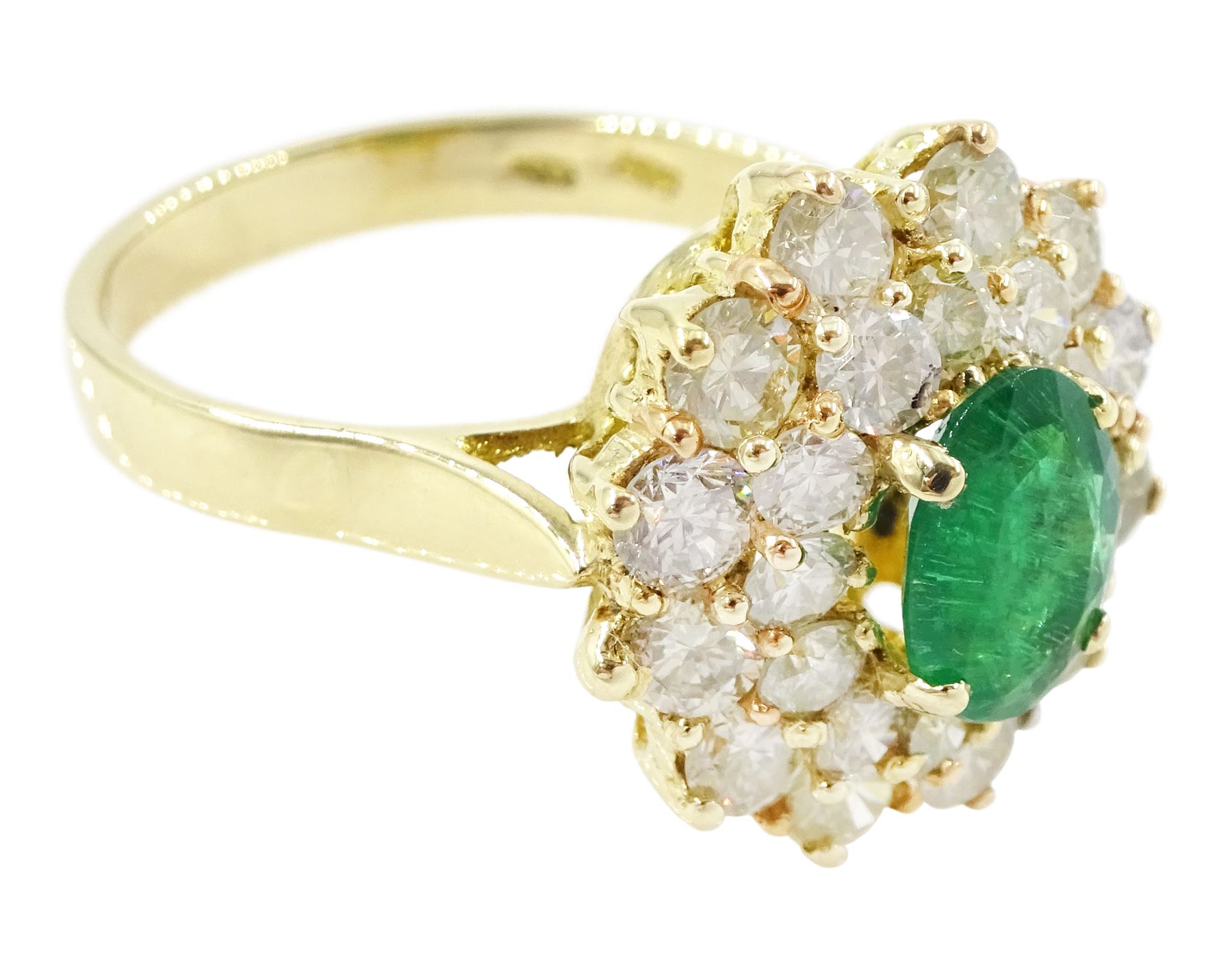 14ct gold emerald and diamond cluster ring, single oval cut emerald of approx 1.05 carat, surrounded by two rows of twenty four round brilliant cut light yellow diamonds, total diamond weight approx 2.35 carat