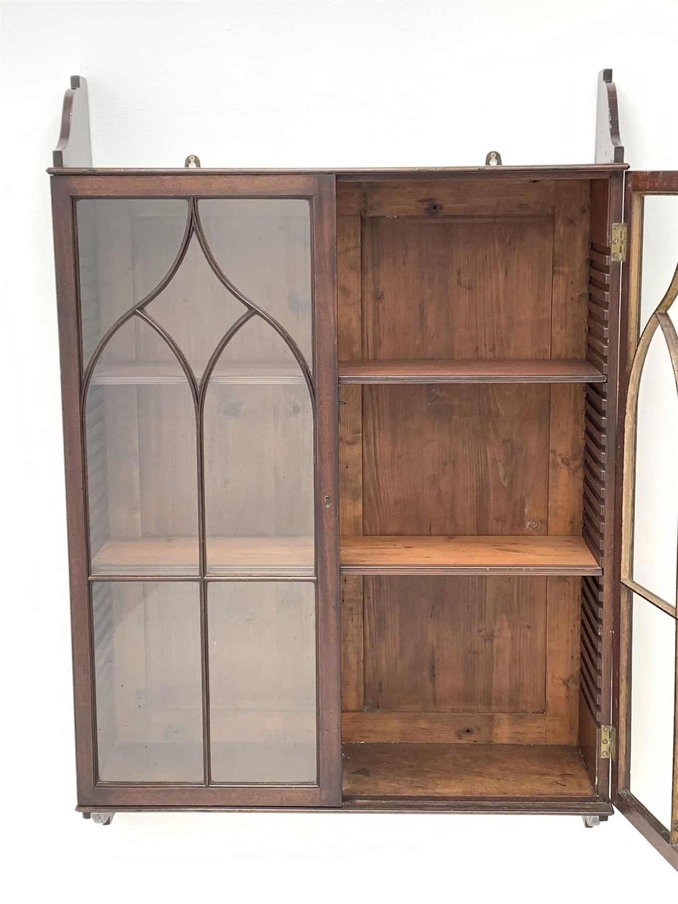 Georgian mahogany Gothic wall hanging cabinet, enclosed by two ogee pointed arch astragal glazed doors, plain sides with shaped top and bottom brackets