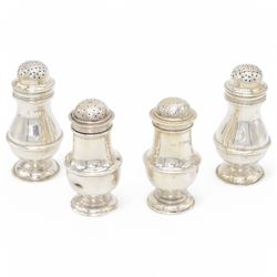 Pair of Edwardian silver muffineers, of urn form, with removable pierced covers and upon d...