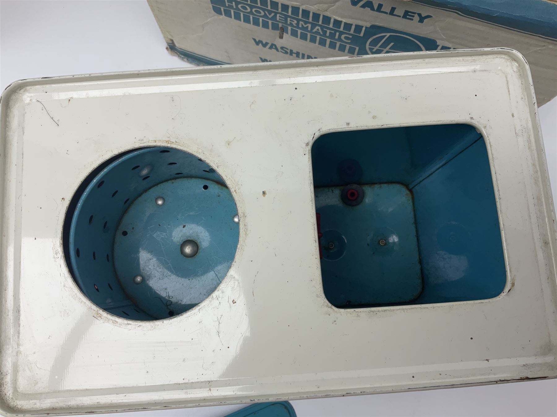 Six toy kitchen appliances - Casdon battery operated cooker; Mettoy Hoover washer; Chad Valley Hoovermatic washer; Wells Brimtoy tin-plate clockwork washer; and two Morphy Richards irons; together with a continental child's Regina sewing machine; all boxed (7)