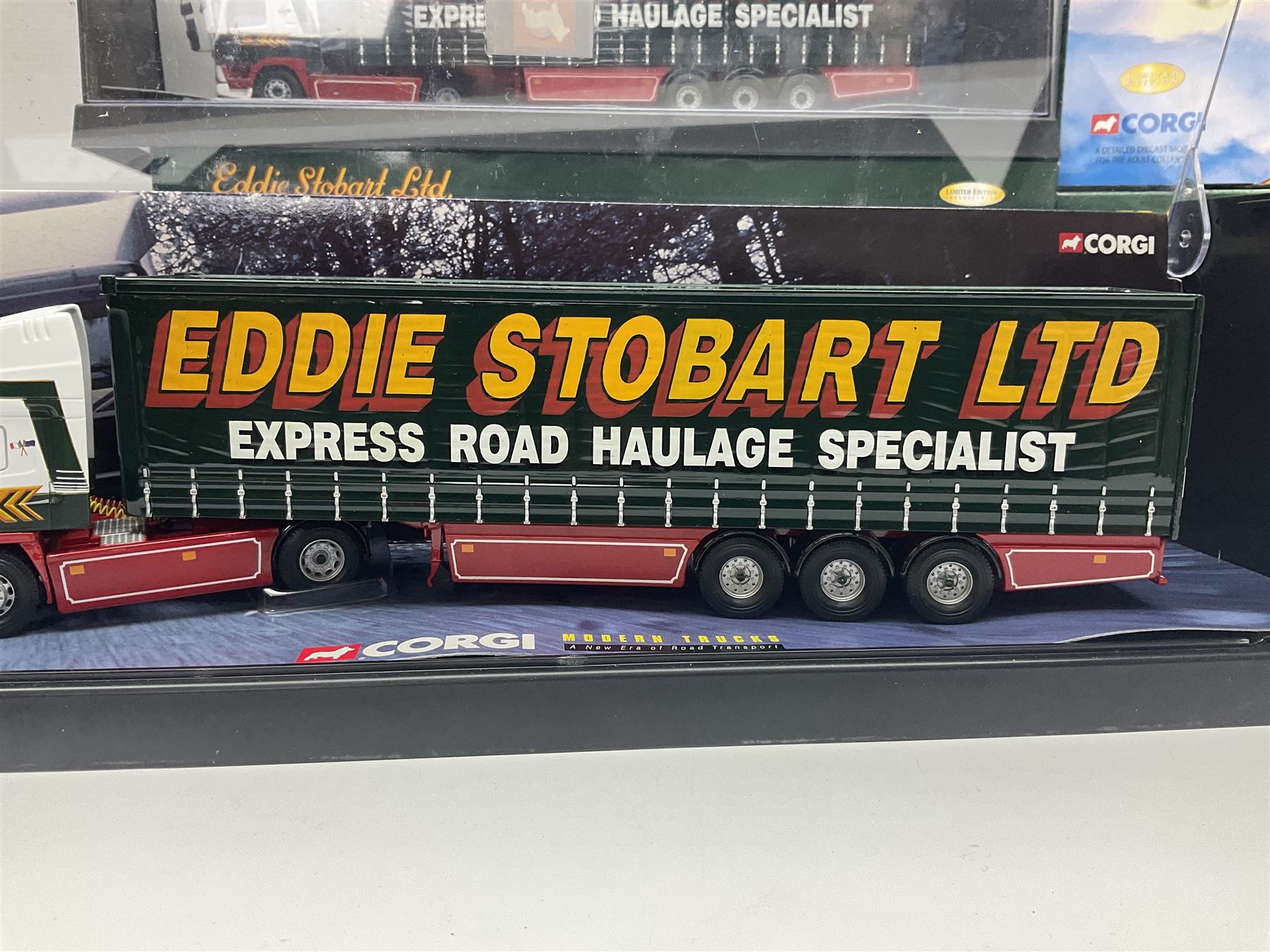 Corgi Eddie Stobart - four heavy haulage vehicles comprising 75201 ERF Curtainside; 75403 Leyland-DAF Curtainside; both in plastic display boxes; CC12610 Scammell Crusader 3 Axle Low Loader; and CC12502 Atkinson Borderer Flatbed Trailer; together with AA30008 Douglas DC-3 Aircraft; all boxed (5)