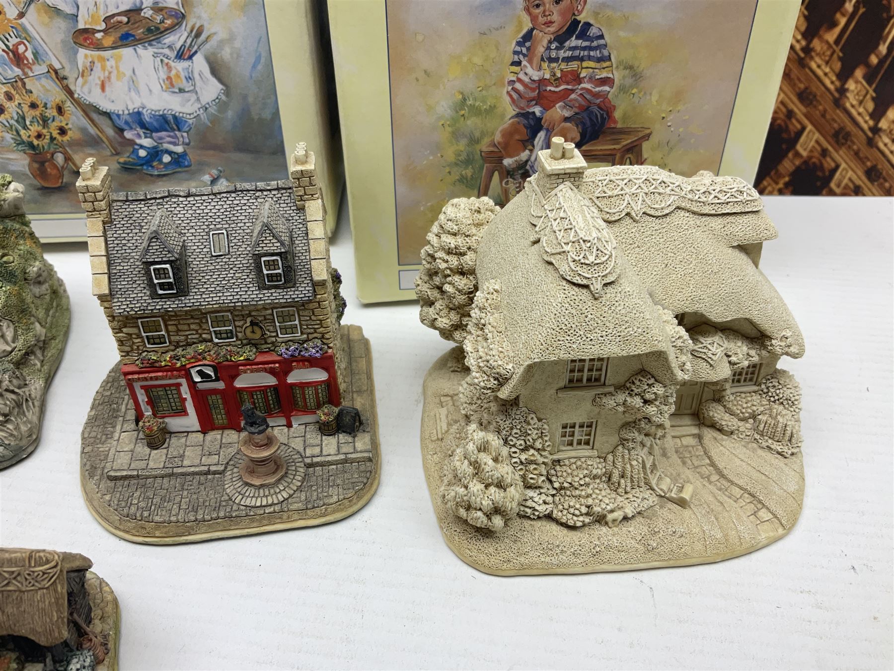 Twenty three Lilliput Lanes, including Village School, Lace's Shoe Shop, Cockles & Muscles, Scotland the Brave etc, together with The Leonardo Collection Paint Box Poppets and Gullivers World magazines 