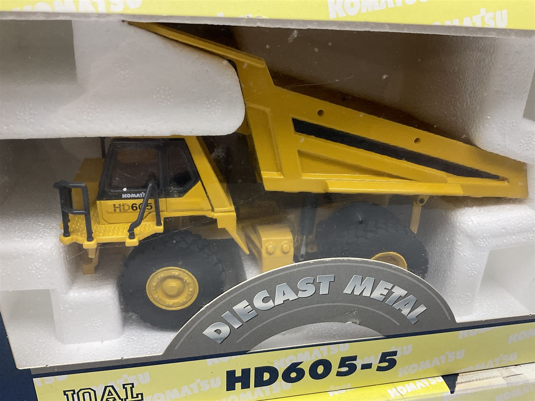 Four Joal Komatsu 1:50 scale die-cast models comprising WA600-3 Log Loader, HD605-5 Dump Truck and two PC1100LC-6 Material Handler, together with a CAT Articulate Truck, all boxed (5)