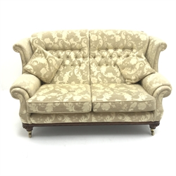 Traditional wing back sofa upholstered in fabric, turned mahogany feet, W166cm