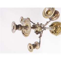A large Victorian Thomas Bradbury & Sons silver plated candelabrum, the circular base with flower head border upon three domed feet, supporting a central knopped and fluted column flanked by three zoomorphic creatures, leading to a central socket with removable nozzle above a large palmette detailed drip pan, and three scrolling branches with conforming sockets and nozzles, with maker's silver plate mark and Victorian registration lozenge beneath, H62.5cm