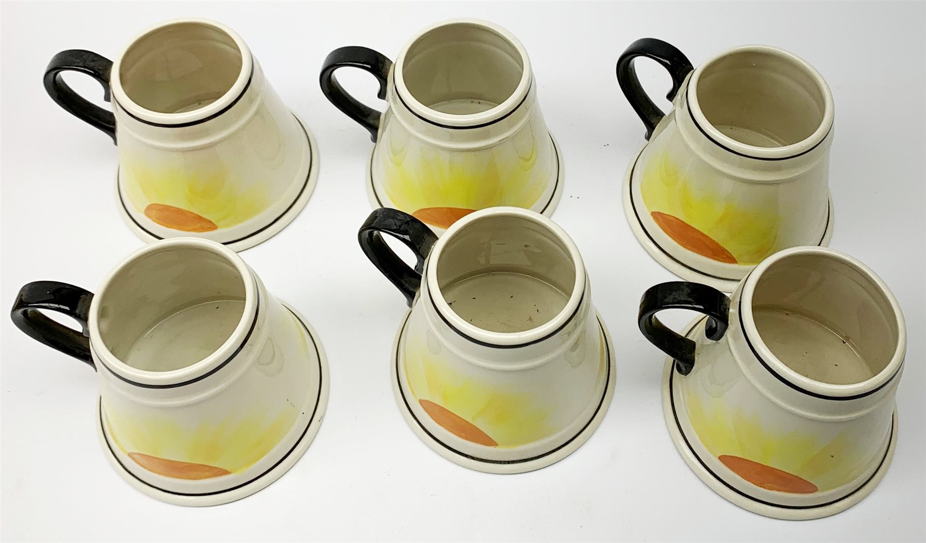 A Carlton Ware Art Deco style coffee set, decorated in the 'Manhatton Sunset' pattern, comprising coffee pot, milk jug, open sucrier, and six coffee cans, all of tapering form, coffee pot H26.5cm. 