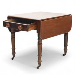 Mahogany drop-leaf Pembroke table circa 1900, with rounded rectangular top and single frieze drawer, raised on turned and tapered supports with brass castors (Extended 128cm)