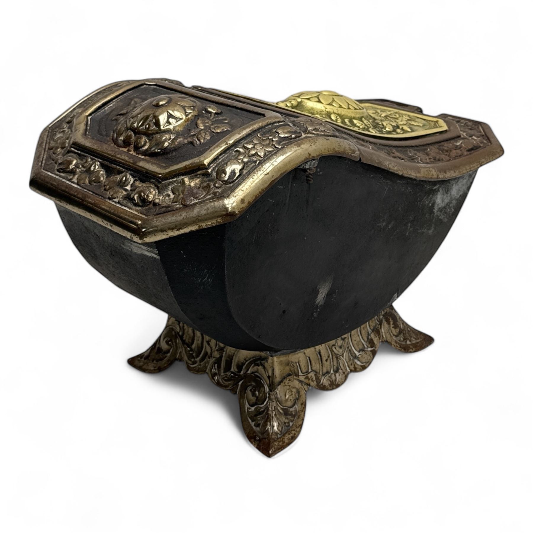 Late 19th century Victorian cast iron and brass purdonium, domed lid with central embossed sunflower and foliage panel within a floral border, flanked by scrolled and foliate detail, raised on shaped feet