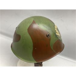 1960s Italian parachutist helmet with liner; camouflage paintwork with parachutist crest to the front