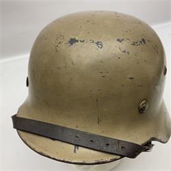 WWII German Luftwaffe M40 steel helmet, sand coloured finish with single decal and leather liner; side apron stamped S.E.64, back apron with indistinct number and top stamped N1