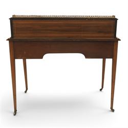 Maple & Co - Edwardian mahogany inlaid writing desk, the superstructure with pierced brass gallery, above an inset mirror and two short drawers, inset leather writing surface, bow fronted with crossbanded drawers and brass swan neck handles, square tapering supports terminating in castors 