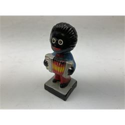 Robinson Jam plaster Golly band, including drummer and singer, H7.5cm

Originally handmade by mothers in Africa for their children from old fabric and cloth, the golly doll was adopted as the mascot and trademark for the Robertson's confectionery brand around 1910 after the company's founder John Robertson visited the US and noticed children playing with them. Robertson's Gollies have been collected by people across the UK and around the world for generations but garnered a contentious image in the 1980s because of links to racism. The trademark was removed from Robertson's branding in 2001.