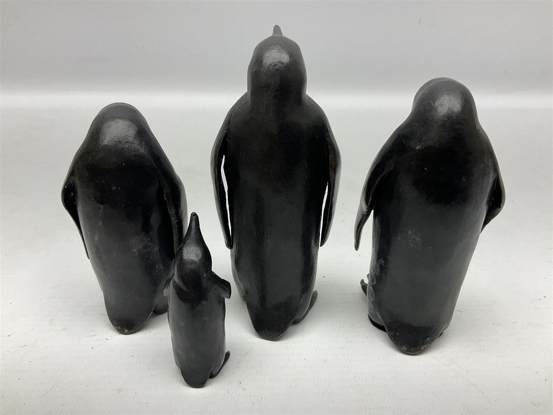 Steve Boss (British 1970-); Bronze figure group of a family of Emperor penguins, entitled Waddle, all with artists monogram beneath, tallest H12cm