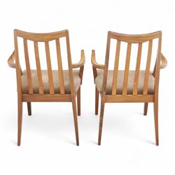 G Plan - mid-20th century teak extending dining table, oval top with integrated extension leaf, raised on tapering legs, together with a set of six slat back dining chairs including two carvers, upholstered in dark green velour (Extends to 210cm)