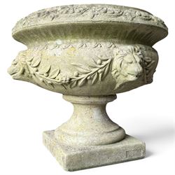 Regency design weathered cast stone garden urn of kylix form, the anthemion and arrowhead ...