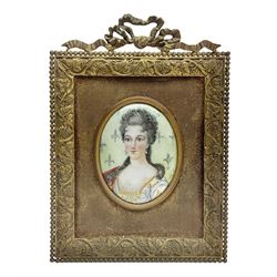 19th century portrait miniature on enamel, depicting a Georgian lady in period dress, hand painted with gilt detailing, in gilt frame with fruiting vine details, overall H13.7cm