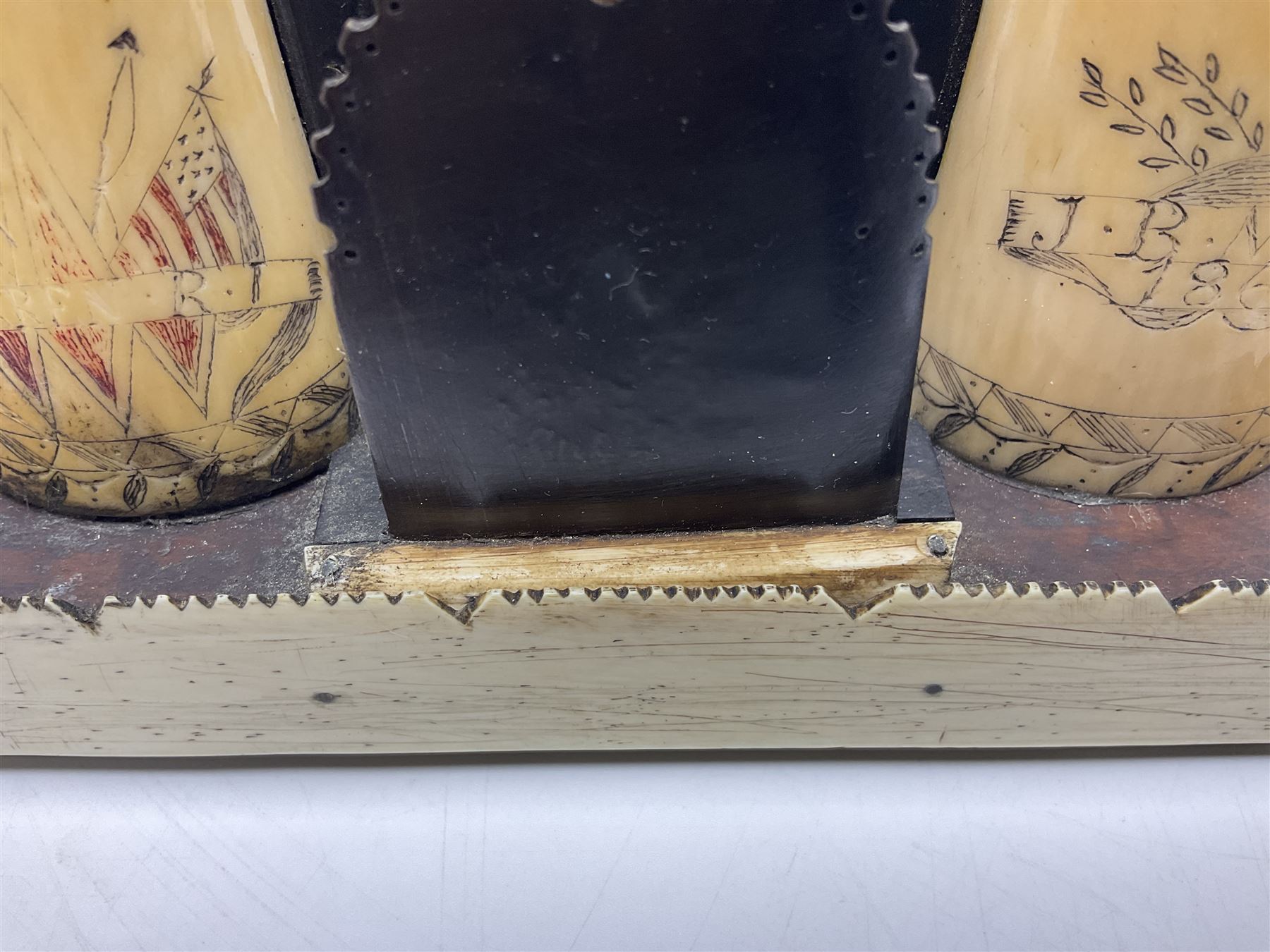 19th century scrimshaw pocket watch stand with two sperm whales teeth and central baleen watch holder; etched for the sailing ship 'Emma' at Warren Rhode Island and dated 1852, H14cm Notes: Warren was an active whaling port from the mid 18th century and became the leading whaling port of Rhode Island in the early 19th century, sending on average twenty whalers per year. The last whaler departed from Warren in 1865, following the decline of the whaling industry. 