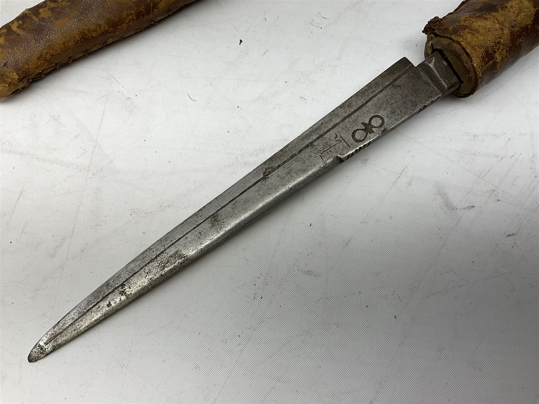 Near pair of African Moroccan Berber tribal Shula daggers each with engraved 39cm curving fullered steel blade, carved and inlaid horn grip and leather covered scabbard L57cm overall; kindjal style dagger with brass covered and jewelled grip and scabbard; another Eastern dagger with leather covered grip and scabbard; and a large Eastern knife with animal hide scabbard (5)