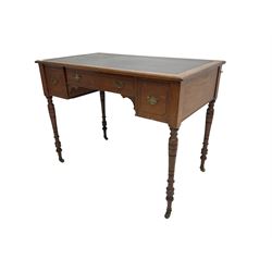 Late 19th century walnut writing table or desk, moulded rectangular top with inset leather, fitted with three drawers, on ring turned supports with brass and ceramic castors 
