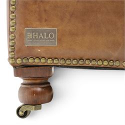 Timothy Oulton for HALO - Two seater brown leather chesterfield sofa, with button back and arms, with two loose cushions, raised on a dark stained supports terminating in castors 