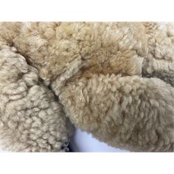 1950s sheepskin plush covered teddy bear with musical movement, the revolving head with applied eyes, leather nose and stitched mouth, jointed limbs with leather pads H50cm