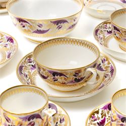 Early 19th century Derby tea and coffee service painted with a border pattern of purple and gilt leaves and flowers comprising four large cups with five saucers, nine coffee cans with twelve saucers, tea pot and stand, slop bowl, milk jug and two plates, red painted mark.