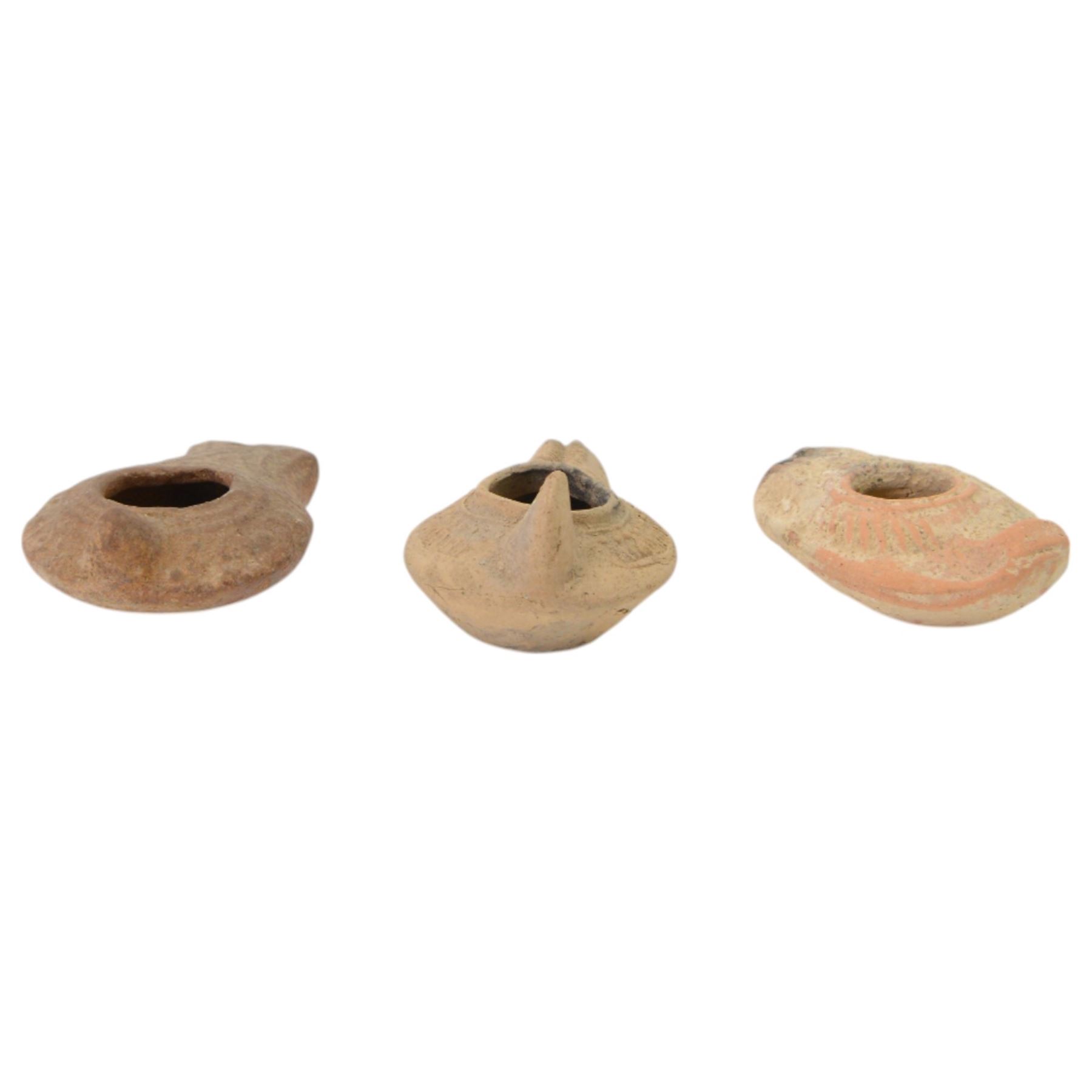 Antiquities; two decorative terracotta Byzantine oil lamps, 4th - 5th century, with decorative spouts, together with two similar examples
