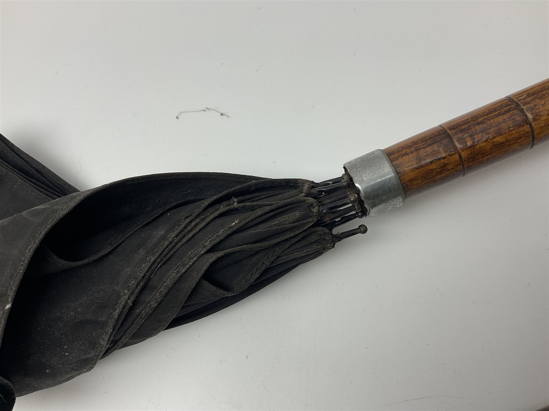 Early 20th century curved horn handle walking stick with hallmarked silver mounts, engraved L Russell 1918, together with a shooting stick by William Mills Birmingham, with leather handle, 'The Featherwaite' shooting stick and an umbrella with wooden handle